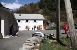 a group of people standing in front of a white building at Peyranère in Urdos