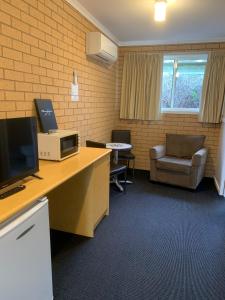 an office with a desk with a computer and a chair at Port Campbell Parkview Motel & Apartments in Port Campbell