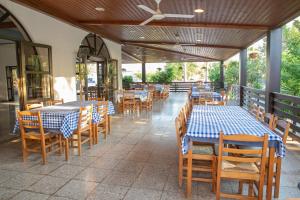 a restaurant with blue and white tables and chairs at West End Hotel in Peyia