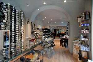 a wine store with a bunch of wine bottles on display at Vinoteca La Sacrestia in Alba