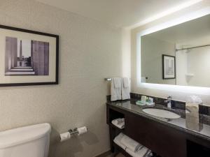 a bathroom with a sink and a mirror and a toilet at Holiday Inn Washington Capitol - Natl Mall by IHG in Washington, D.C.