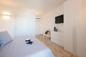 a bedroom with a bed and a tv on a wall at Amalfi Casamia B&B in Amalfi +25 photos