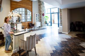 a woman standing at a counter in a room at Predela 2 Aparthotel in Bansko +181 photos