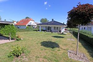 a yard with a house and a tree in it at Ferienhaus Zecherin USE 3451 in Zecherin