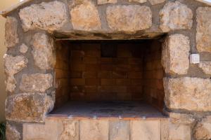 a brick oven in a stone wall at Apartment Pod Nespolom in Trsteno