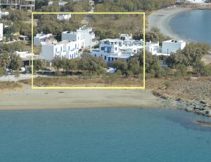 an aerial view of a beach with white buildings at Nostos Beachfront Apartments & Studios in Agios Ioannis