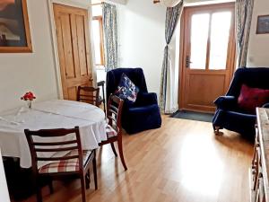 a living room with a table and chairs and a room with a window at Little Barn Highfields Farm in Hilderstone