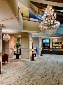a lobby with chandeliers in a hotel at Poiana Brasov Alpin Resort Apartment in Poiana Brasov