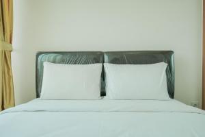 Ένα ή περισσότερα κρεβάτια σε δωμάτιο στο Wonderful Studio Apartment at Tree Park City BSD By Travelio +8 φωτογραφίες