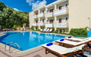a hotel with a swimming pool and lounge chairs at Agrimia Holiday Apartments in Plataniás