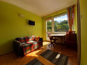 a living room with a couch and a table at Pensjonat Osemka in Lewin Kłodzki