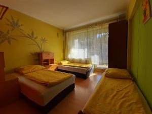 a room with three beds and a window at Pensjonat Osemka in Lewin Kłodzki