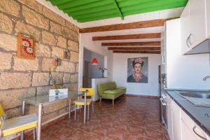 cocina y sala de estar con mesa y sillas en Casa Tabaiba - Villa Perenquén, en Guía de Isora