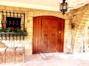 a wooden door on a stone building with a window at Villa in Toscana a due passi da Saturnia in San Giovanni delle Contee