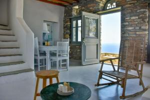 a room with a staircase and a table and chairs at Living Theros Luxury Suites in Kardhianí