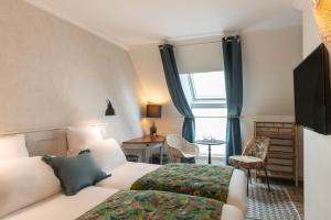 a hotel room with a bed and a window at Hotel Touraine Opera in Paris +30 photos