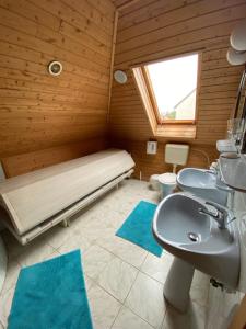 a bathroom with two sinks and a bed in a room at B&B Chardas in Bük +87 photos