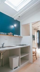 a kitchen with a white counter and a sink at Terres de France - Domaine de Kerioche in Rochefort-en-Terre