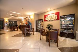 a restaurant with tables and chairs and a bar at White Lion Hotel in Ho Chi Minh City