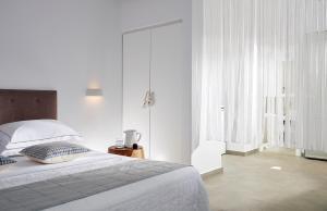 Ein Bett oder Betten in einem Zimmer der Unterkunft Santa Maria Luxury Suites & Spa