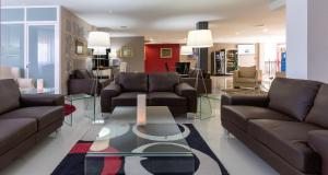 a living room with couches and a coffee table at Chateau La Roca in Sancibrián