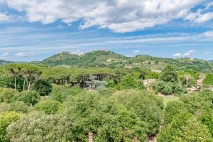 a view of a mountain range with trees and houses at Grand Hotel Croce Di Malta in Montecatini Terme