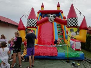 a group of people standing around a inflatable play structure at Domki Klif Rusinowo in Rusinowo