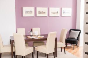 a dining room with a table and white chairs at Stephansdom Premium Apartments in Vienna