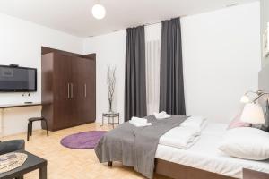 a hotel room with a bed and a tv at Stephansdom Premium Apartments in Vienna