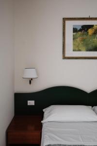 a bedroom with a bed and a picture on the wall at La Girandola Bed & Breakfast in Rome