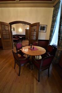 a dining room with a wooden table and chairs at Hotel Eifeler Hof Kyllburg in Kyllburg