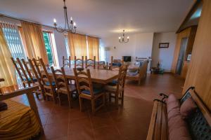 een eetkamer met een houten tafel en stoelen bij Casa dos Peliteiros in Vilarinho