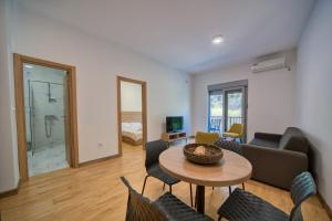 a living room with a table and chairs at Trsteno Beach Apartments in Budva