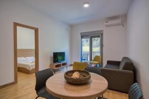 a living room with a table and a couch at Trsteno Beach Apartments in Budva