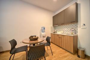 a kitchen with a table and chairs in a room at Trsteno Beach Apartments in Budva