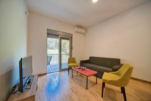 a living room with a couch and a table at Trsteno Beach Apartments in Budva
