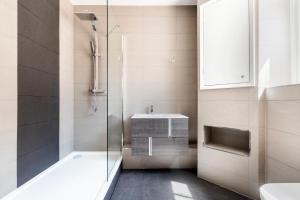 a bathroom with a shower and a sink at Marble Arch Mews Apart'hotel in London