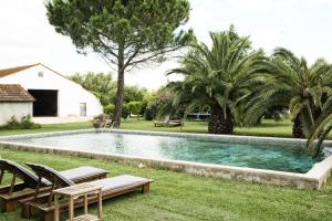 a swimming pool in the yard of a house at Mas de Bouvet en Camargue in Albaron