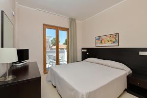 Postel nebo postele na pokoji v ubytování Hotel Mareluna