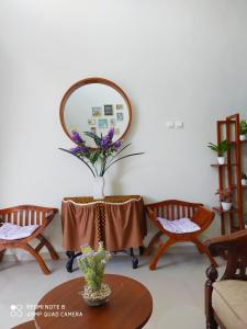 Cette chambre comprend une table avec un miroir et des chaises. dans l'établissement Alysahouse - 2 Bedrooms, Dekat JTP3, à Batu