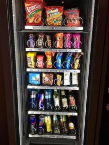 a refrigerator filled with lots of drinks and snacks at SleepySleepy Hotel Dillingen in Dillingen an der Donau