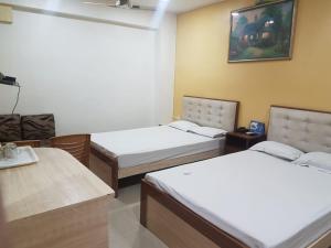 Postel nebo postele na pokoji v ubytování Jimmy Guest House