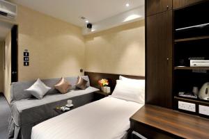 a bedroom with two beds with pillows at Mingle With The Star in Hong Kong