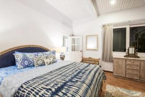 a bedroom with a blue and white bed and a window at Villa Alexandra Seminyak in Kerobokan +24 photos