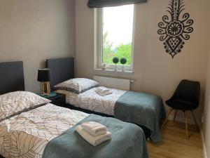 Posteľ alebo postele v izbe v ubytovaní Apartament przy Olimpijskiej