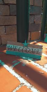 a sign on the ground next to a pole at Violetta Studios & Apartments in Mil&iacute;na