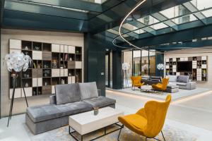 a living room with a couch and chairs at Hotel Vision in Budapest