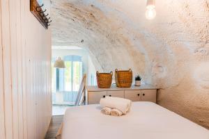 a bedroom with a bed with towels on it at Finca Les Coves in Jijona +200 photos