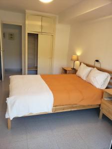a bedroom with a large bed with white sheets at Apart.3 habit.mar-mont. AC-Terraza-ascensor-parking in Calella