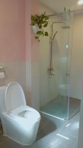 a bathroom with a toilet and a glass shower at Triple-T Homestay in Vung Tau